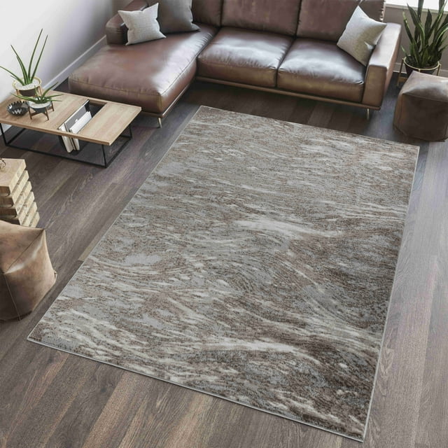 Abstract modern wave pattern indoor area rug from Rug Branch Sakarya Collection in neutral beige and gray tones, displayed on wood flooring under a brown leather sectional sofa.