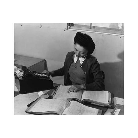 Photo Of Th Mrs Teruko Kiyomura bookkeeper seated at a desk operating an adding machine while reading a ledger Ansel Easton Adams was an American photographer best known for his black-and-white photographs of th ()