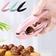 thumbnail image 1 of Clip de apertura de castaños | Tijeras peladoras para frutos secos, fruta, nuez, avellana | Mango ergonómico de ABS, diseño fácil de limpiar, pack de 2 + garra castaño extra | Cascanueces flexible, 1 of 7