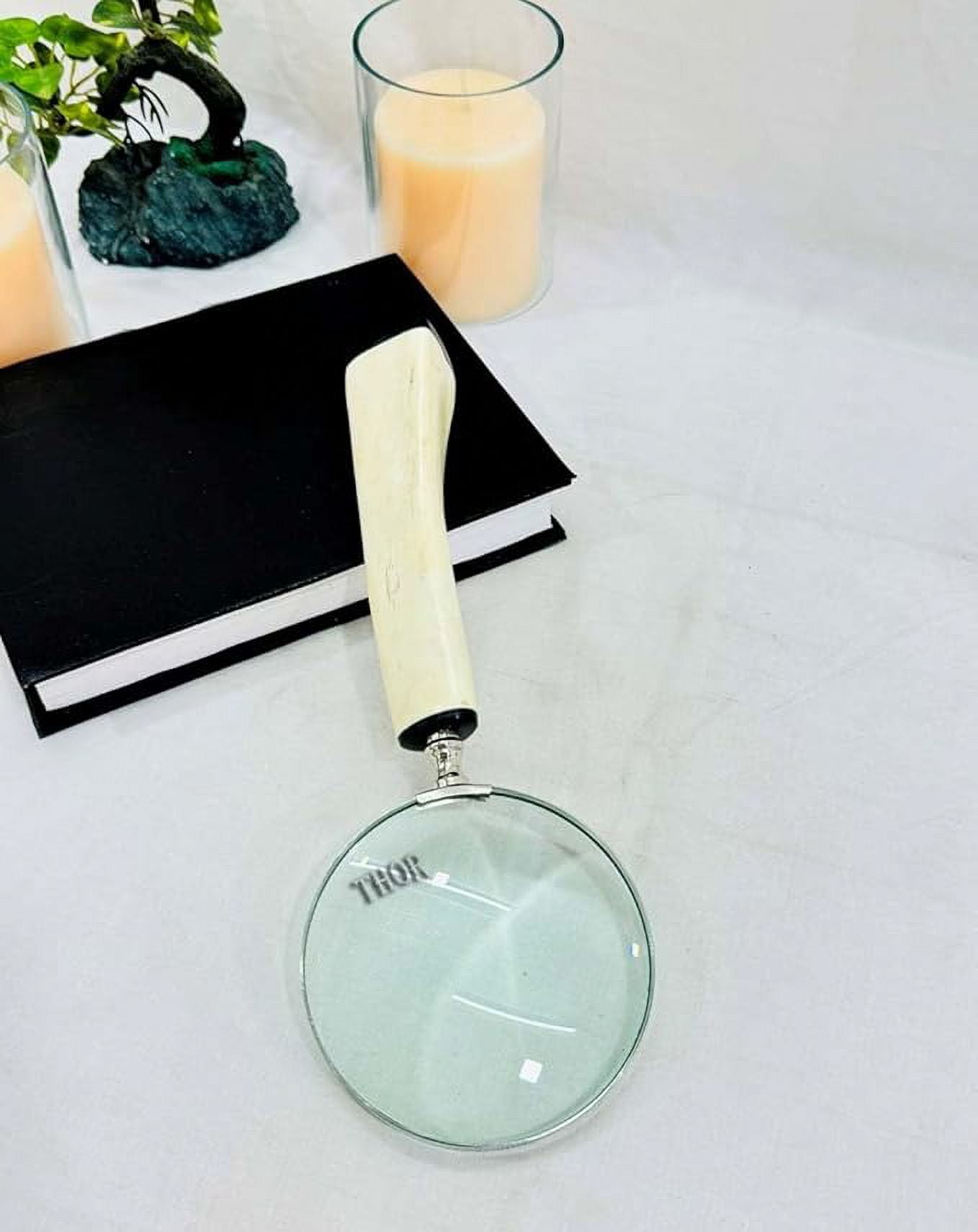 Magnifying glass hand lens in a vintage nautical style 11 inches long. 4 inch diameter lens with a marquetry design handle