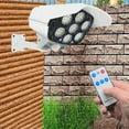 thumbnail image 1 of Lámpara de pared solar con cámara de seguridad falsa | Sensor de movimiento y control remoto | 3 modos de iluminación | 77 LED de alto brillo | Foco de patio de jardín al aire libre con energía, 1 of 8