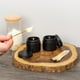 thumbnail image 4 of Frascos de vidrio Cornucopia de 60 ml con revestimiento negro y tapa de metal negro, 4 of 9