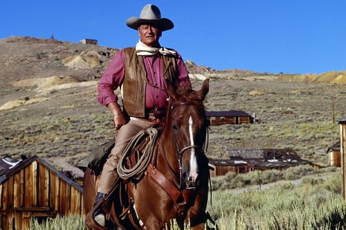 John Wayne in Chisum iconic pose on horseback by western town legend