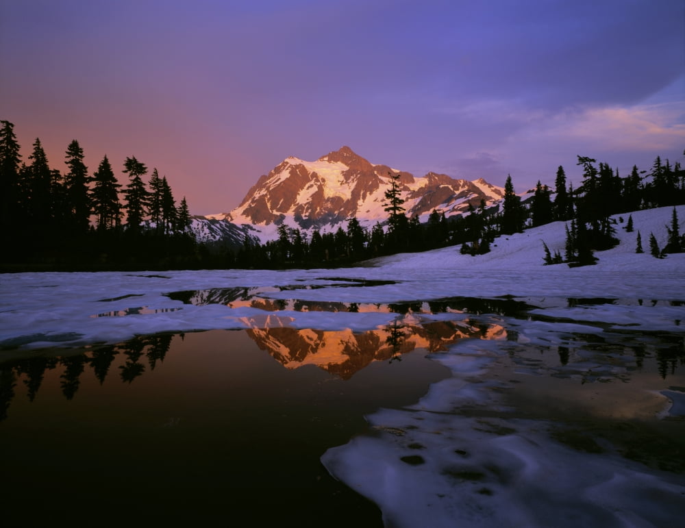 Mt Shuksan reflecting into a partial ice covered Picture Lake at sunset Mt Shuksan is in North Cascade National Park and Picture Lake is in Mt Baker Snoqualmie National Forest Washington Canvas Art -