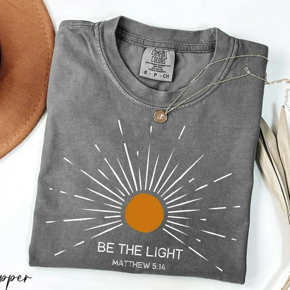 Christian “Be the Light” T-Shirt – Matthew 5:14 Bible Verse Tee with Radiating Sun Graphic