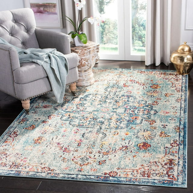 SAFAVIEH Madison Joandra vintage floral area rug featuring blue, orange, and cream colors displayed in a bright living room with gray armchair and decor.