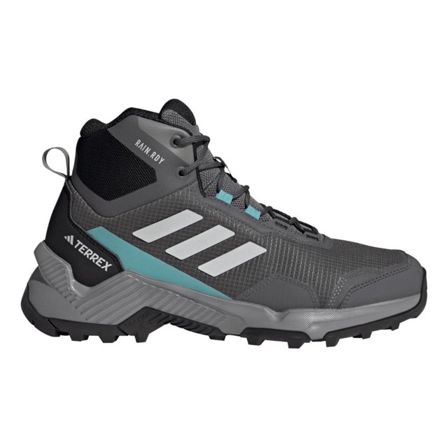 botas adidas mujer dama senderismo terrex eastrail 2 rain rdy gris oscuro 2,0 mx bota de caña media gris oscuro, vista lateral derecha con tres franjas blancas, panel texturizado y detalle azul verdoso en la entresuela; suela de goma con dibujo de tracción pronunciada y cordones negros, etiqueta 'RAIN.RDY' en el tobillo. Suele utilizarse para senderismo y desplazamientos urbanos.