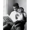 Close-up of a son sitting on his fathers lap reading a book Poster Print