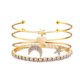 thumbnail image 1 of Juego de 4 pulseras de cristal con forma de estrella y luna, multicapa, con apertura en forma de corazón (doradas), 1 of 7
