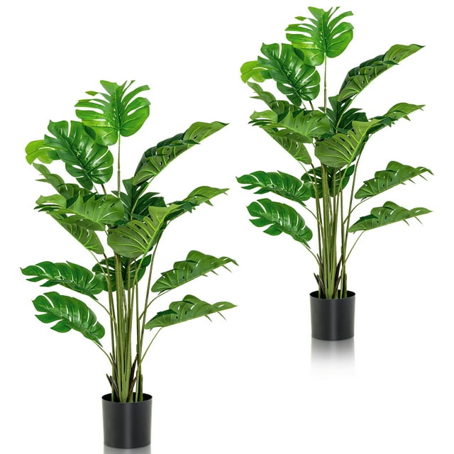 Gymax 2-Pack 5 ft Artificial Trees with lifelike monstera deliciosa leaves in black cement pots. Each tree features 15 verdant green leaves with realistic textures and simulated moss for added natural appeal. Made from durable PEVA material, these faux plants are perfect for indoor or outdoor decoration in living rooms, offices, or porches.