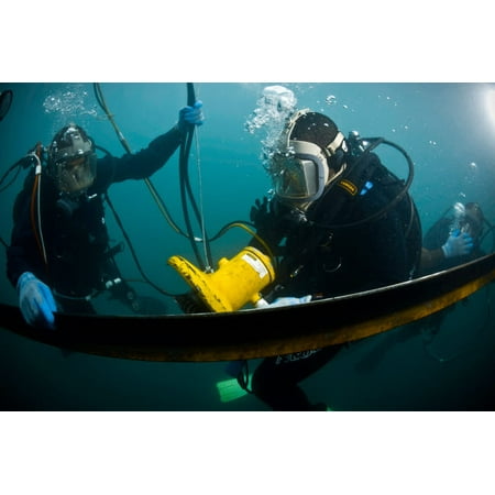 US Navy Diver instructs a Barbados coast guard diver on using a hydraulic grinder underwater Poster Print by Stocktrek