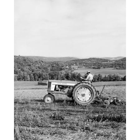 Side profile of a farmer plowing a field with a tractor Quechee Vermont USA Poster