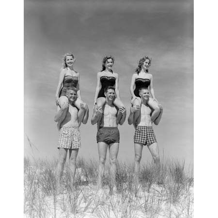 1950s-1960s Three Couples At Beach On Dunes With Women In Identical Bathing Suits Sitting On MenS Shoulders Print
