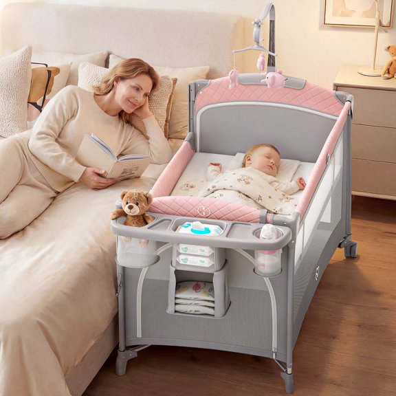 Babyomi 5 in 1 Baby Bassinet Bedside Crib, Easy Folding Portable Playards, Pack and Play with Mattress, Diaper Changer and Music Mobile Pink