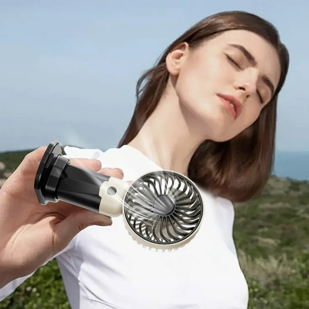 Ventilador portátil USB pequeño de tres velocidades con base de carga para escritorio que se puede usar como soporte para teléfono móvil.