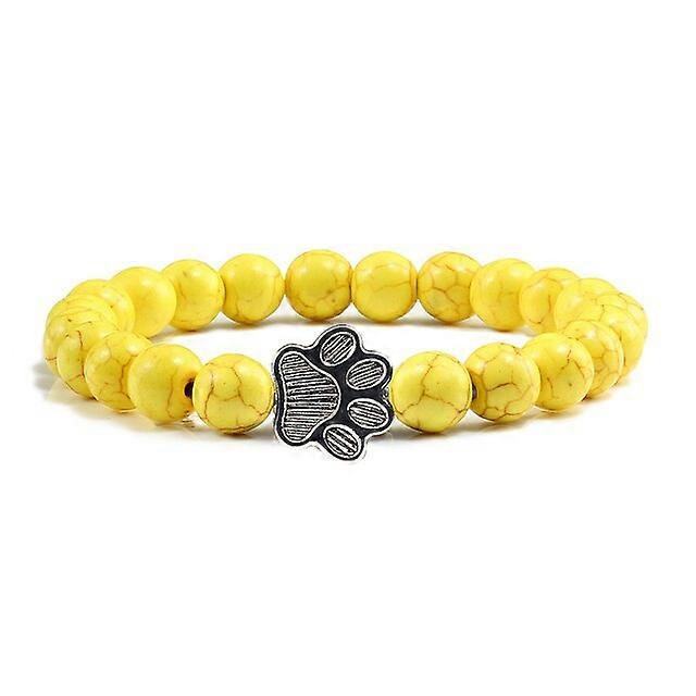 Pulsera con dije de huella de pata de piedra volcánica de lava negra mate natural, ideal como recuerdo para mascotas, amantes de los gatos y los perros.