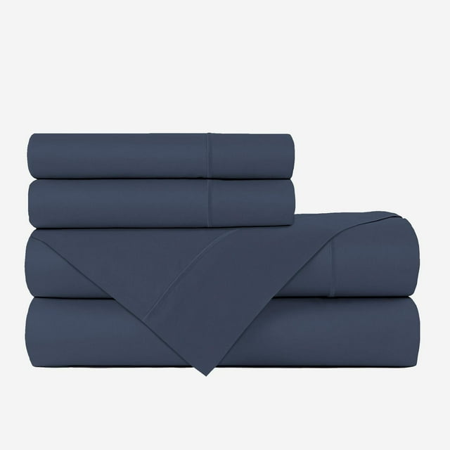 Navy blue Johnson Home 500 Thread Count Liquid Cotton Sheet Set with folded fitted sheet, flat sheet partially unfolded, and two pillowcases stacked.