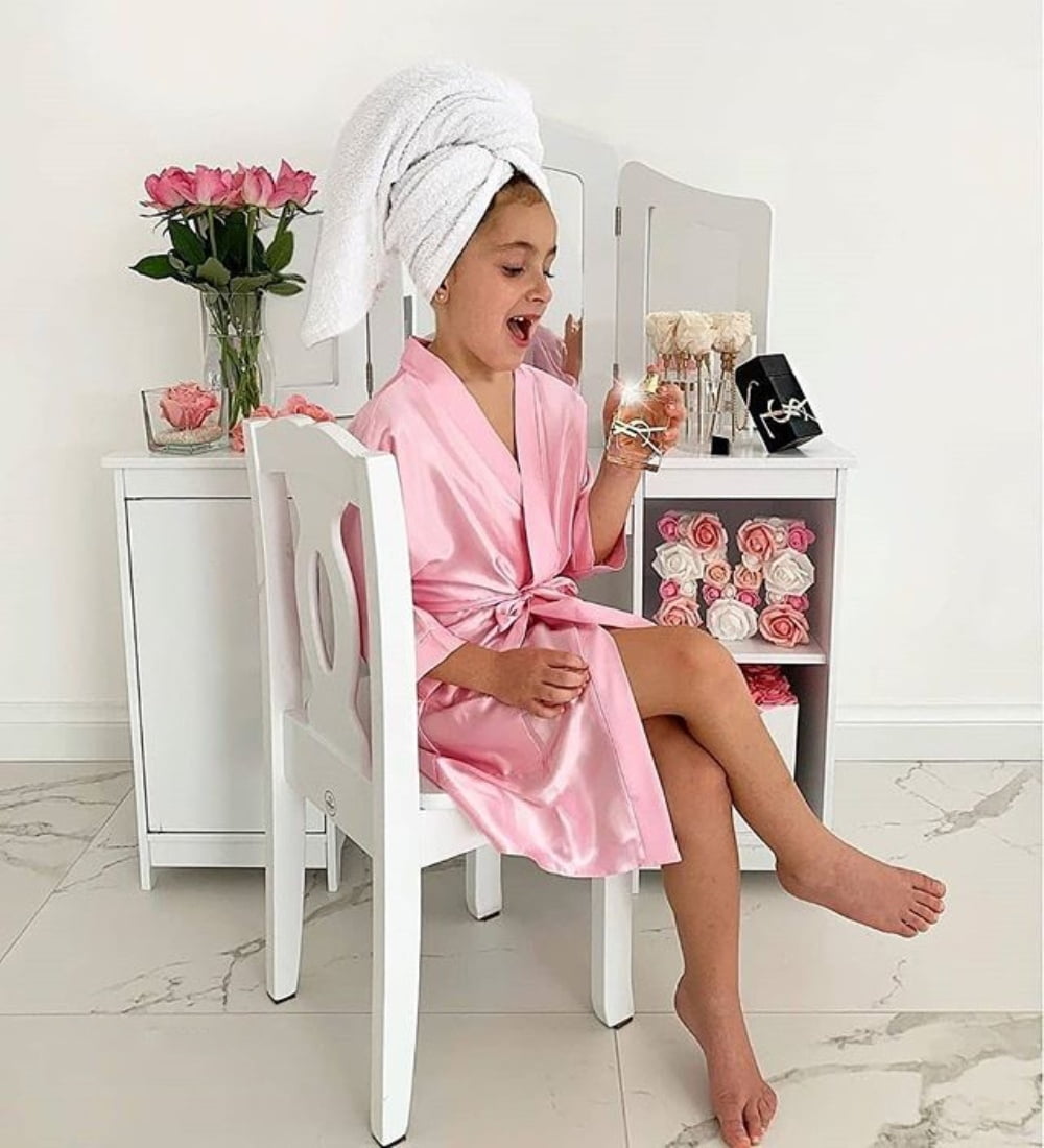 Affectionate mother wearing dressing gown wrapped bath towel on head  embraces and kisses with love her small daughter pose together at home  against cozy interior feel refreshed after taking shower 7799357 Stock