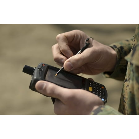 US Marine using GPS capabilities on a handheld device to check his location Canvas Art - Stocktrek Images (35 x 23)