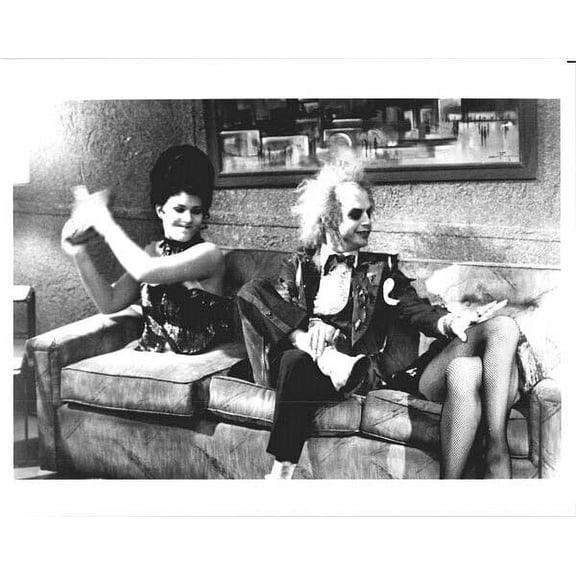 Beetlejuice Michael Keaton sits on sofa next to pair of legs 8x10 inch photo