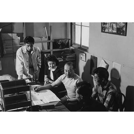 Roy Takeno addresses four members of his staff while seated at a desk in front of an open newspaper  Ansel Easton Adams was an American photographer best known for his black-and-white photographs of