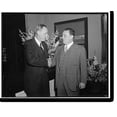 thumbnail image 2 of Historic Framed Print, Leon Henderson shortly after being sworn in as member of Securities & Exchange Commission. Being congratulated by Harry Hopkins, Secy. of Commerce, 17-7/8" x 21-7/8", 2 of 9