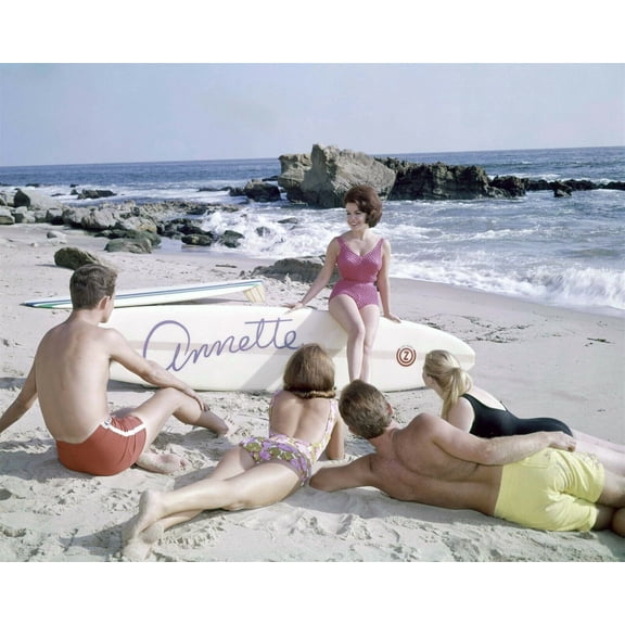 Annette Funicello in pink swimsuit on beach sits on Annette surfboard 8x10 photo