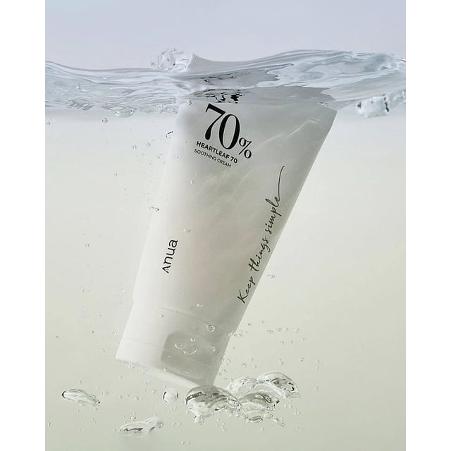 Anua Heartleaf 70% Soothing Cream shown partially submerged in water, highlighting its lightweight gel texture and hydrating benefits. The white tube features minimalist branding with '70% Heartleaf' prominently displayed, ideal for calming sensitive, dry skin. Suitable as a face moisturizer for daily use.