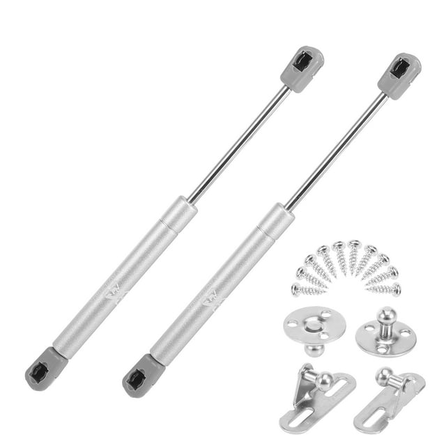 Unique Bargains 2pcs 10inch 45N/10Lb Universal Gas Spring Shock Lift Supports Gas Struts for RV, car, and boat. The image shows two silver-tone metal gas springs with grey connectors, accompanied by screws, round connectors, and rectangular connectors. Designed for easy installation, these gas struts provide hands-free support for medium to heavy objects like car lids or barriers. Extended length is 24cm (9.45 inches), and compressed length is 15cm (5.91 inches).