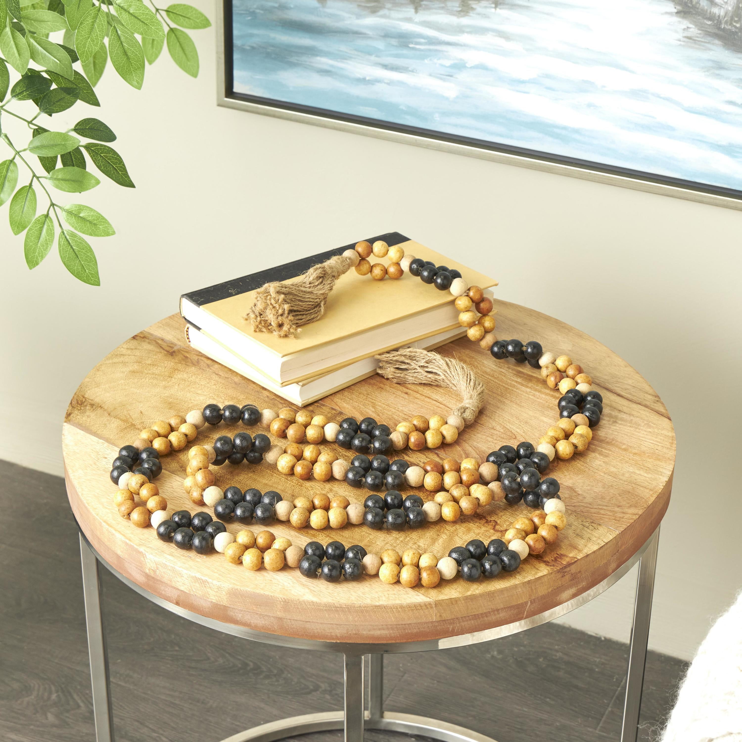 DecMode Handmade Round Double Layered Long Carved Brown Mango Wood Garland with Tassel with Black and Cream Accents