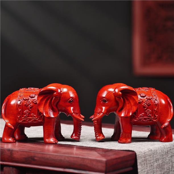 A pair of red solid wood carved elephant figurines, auspicious symbols for home decor, used to fill in missing corners in the living room, and as decorative crafts.