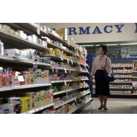 Mid adult woman looking at medicines in a pharmacy Canvas Art -  (18 x