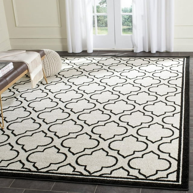 Safavieh Amherst Wilson black and white geometric area rug displayed in a modern living space with natural light.