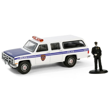 Diecast 1985 GMC Suburban 2500 "New York City Transit Police Department" White with Blue Stripes and Police Officer Figure "The Hobby Shop" Series 16 1/64 Diecast Model Car by Greenlight
