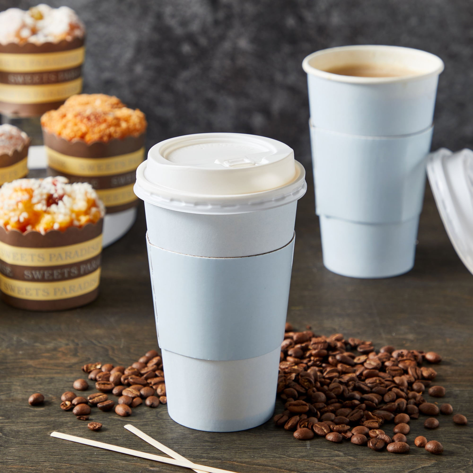 cappuccino and latte in disposable paper cups on a light