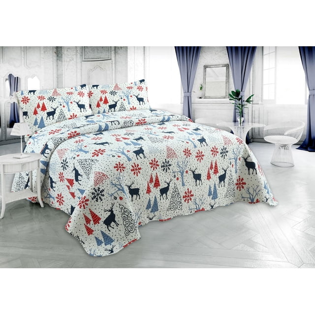 Ultra soft Christmas quilt set featuring embossed pinsonic coverlet with reindeer, tree shapes, and snowflakes in red and blue tones on white bedding.