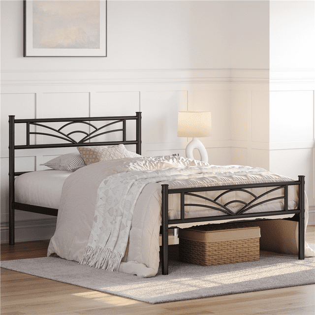 Twin black metal platform bed frame featuring a cloud-inspired design on the headboard and footboard, styled with neutral bedding in a sunlit room.