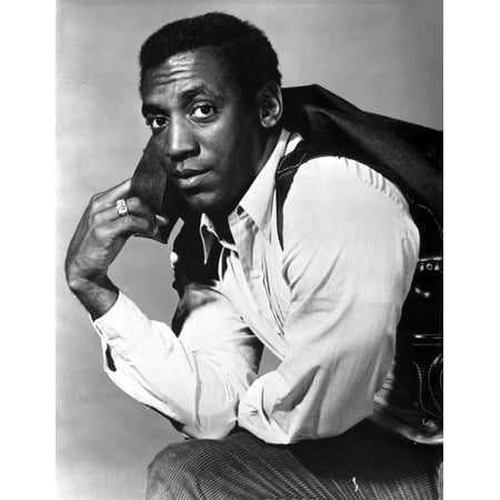 Bill Cosby with his jacket over his shoulder Photo