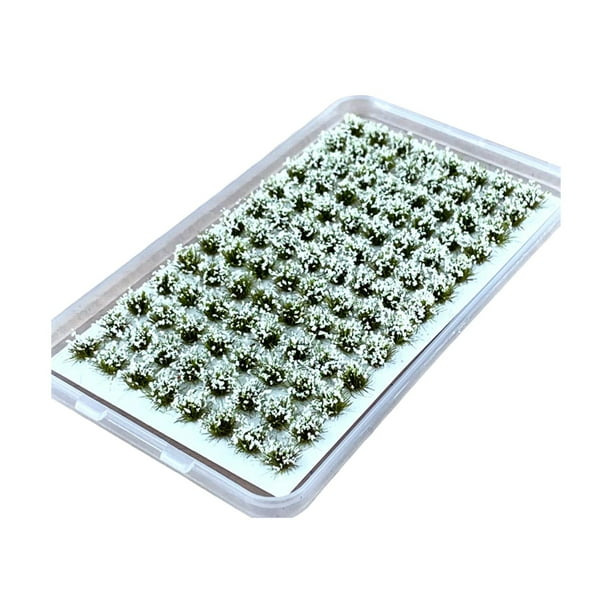 Racimos de flores artificiales en miniatura, matas de hierba, modelos de flores y vegetación. Blanco