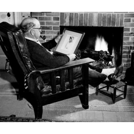 Man looking at old photograph by fireplace Canvas Art -  (24 x (Best Place To Print Large Canvas Photos)