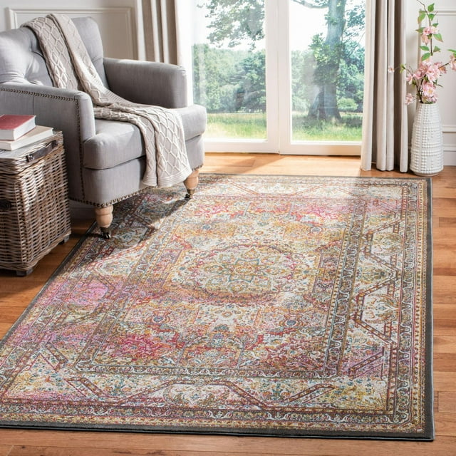 SAFAVIEH Luxor Ethelyn floral bordered area rug with detailed multicolor design on hardwood floor next to gray armchair and wicker basket.