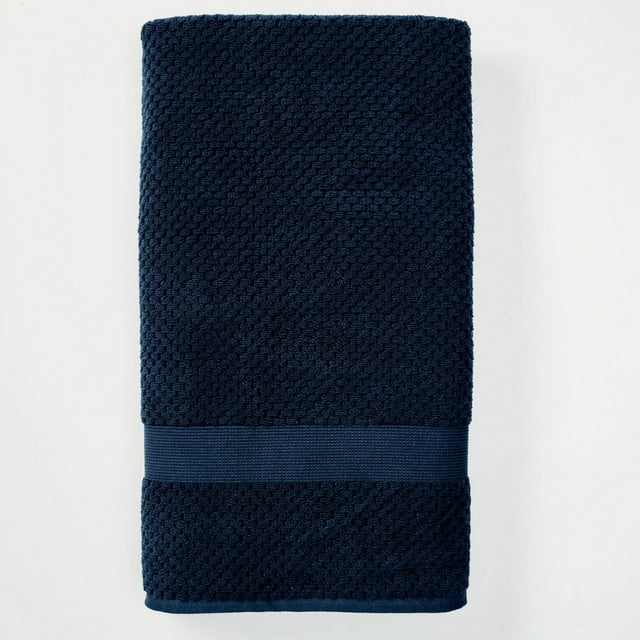 Folded navy blue Better Homes & Gardens Signature Soft Popcorn Texture Towel with a textured pattern and smooth band