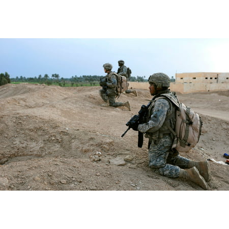 Canvas Print U.S. Army soldiers set up a security perimeter as fellow soldiers search houses for weapons or dange Stretched Canvas 10 x