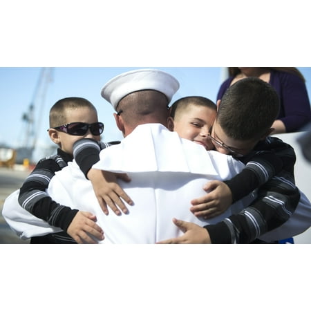 October 29 2013 - US Navy sailor embraces his sons during a homecoming celebration at Naval Base San Diego California Poster
