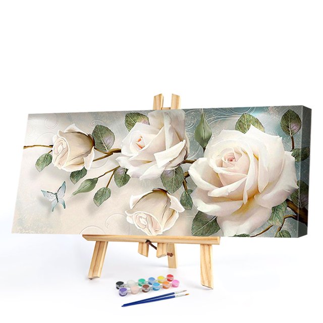 cuadros decorativos kits de pintura al óleo de rosa blanca por números diy lienzo cuadro de pared artesanía decoración del hogar kit sin marco, vista 3/4 frontal en caballete con lienzo 80x40 cm que muestra rosas blancas y hojas en tonos suaves, set de pinturas acrílicas multicolor y tres pinceles delante; textura del lienzo visible sobre fondo blanco; ideal para bricolaje y pintura por números, adecuado como regalo.