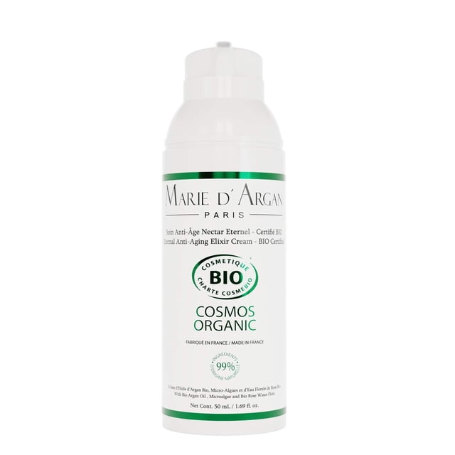 tratamiento antiedad marie d'argan natural orgánico vegano antiarrugas para piel seca y madura — Dispensador blanco cilíndrico con etiqueta verde y logo M A MARIE D'ARGAN; frontal muestra sello 'COSMOS ORGANIC' y texto que destaca Aceite de Argán, Microalgas de Oro y Agua Floral de Rosas, indicado como hidratante intenso para rostro y cuello, uso día y noche; también suele ser práctico para llevar en el neceser de viaje.