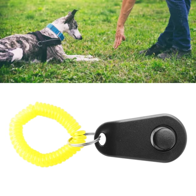 Dog Training Clicker With Wrist Strap Interactive Squeaky Comfortable Universal Training Clicker Rings for Cats, Puppy, Birds, and Horses. The clicker features a compact oval shape with a black ABS body and a bright yellow coiled wrist strap for easy handling. It includes a finger ring design for a secure grip and emits a crisp sound to attract pets' attention. Shown in a lifestyle setting with a dog being trained outdoors on grass.