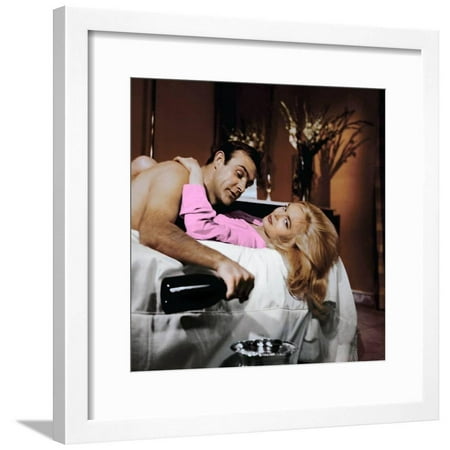 Goldfinger by GuyHamilton with Sean Connery (James Bond 007) and Shirley Eaton, 1964 (champagne Dom Framed Print Wall