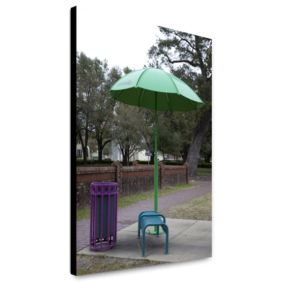 Canvas Print: A Colorful Bench, Umbrella And Trash Can Adorn The City Streets In
