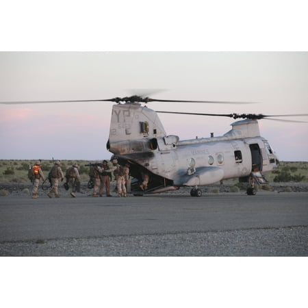 - May 5 2010 - US Marines board a CH-46 Sea Knight helicopter to conduct training in night operations at Marine Corps Air Station Yuma Arizona Poster Print